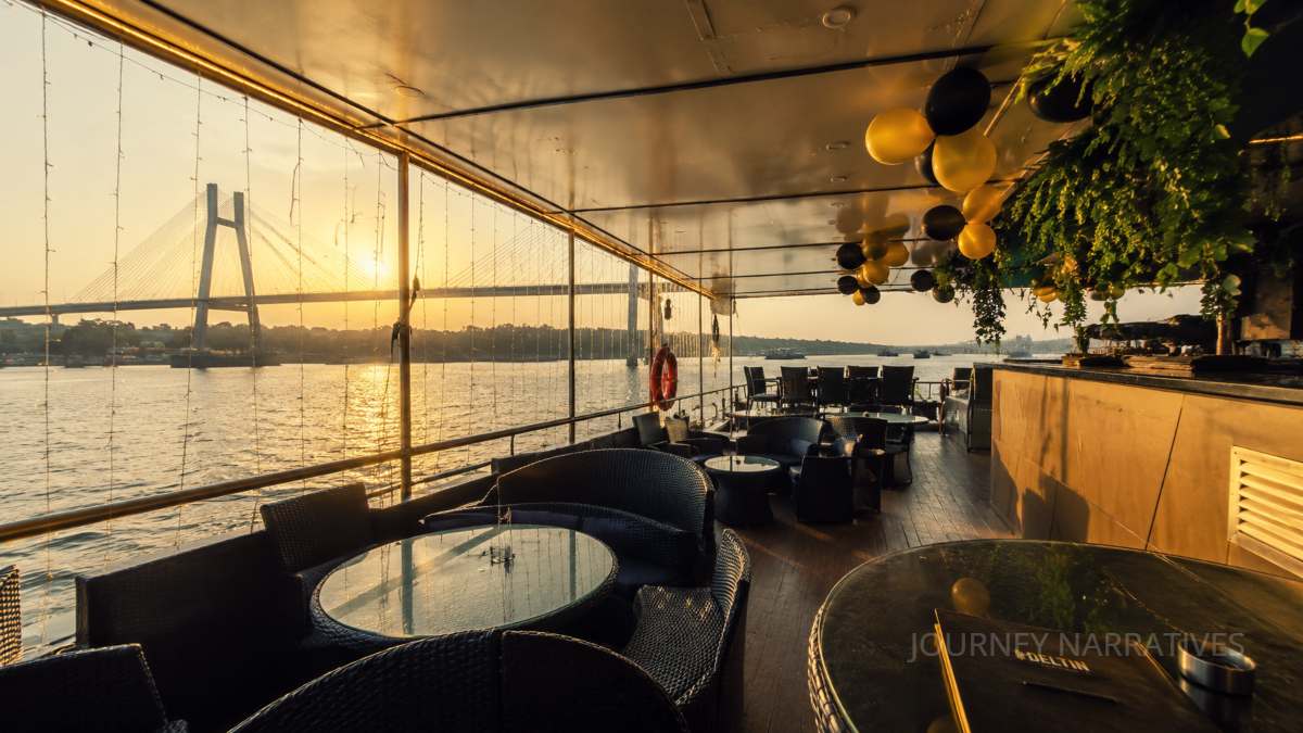 Evening time river cruise on the Mandovi River with beautiful bridge views in Panaji