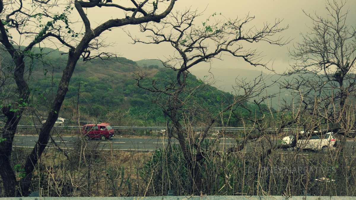 Vehicles traveling through scenic hill roads representing efficient and balanced travel planning in India